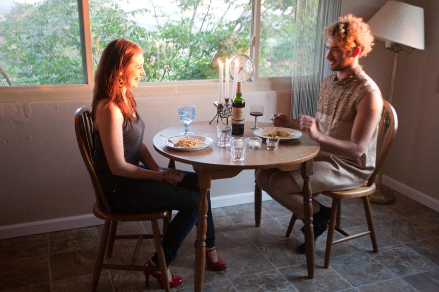 artist and guest sitting at table with food