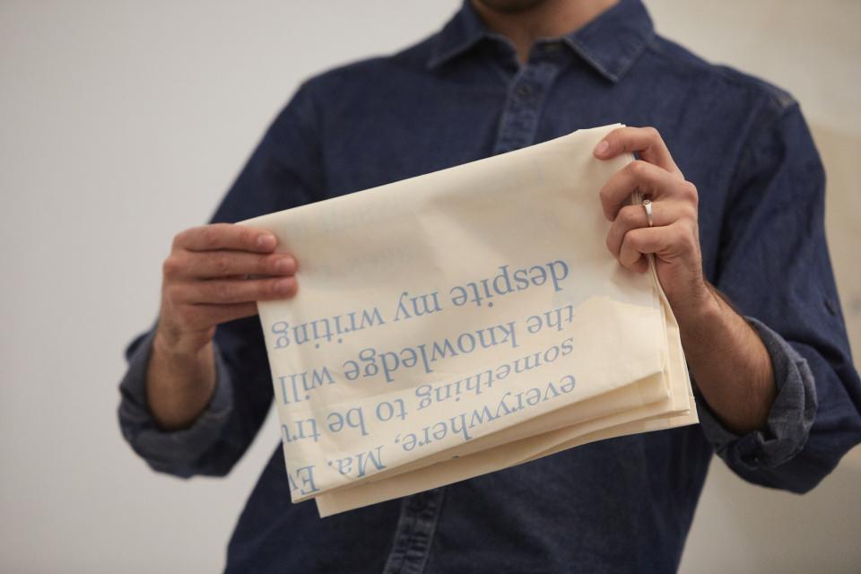 artist holds folded fabric with both hands