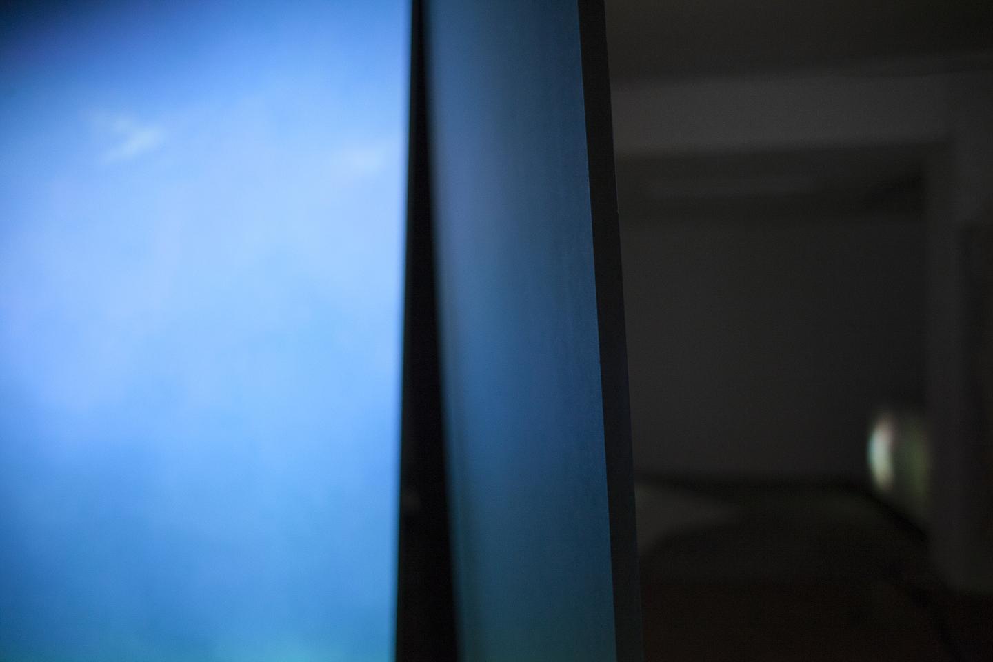 blue projection on two wood panels 