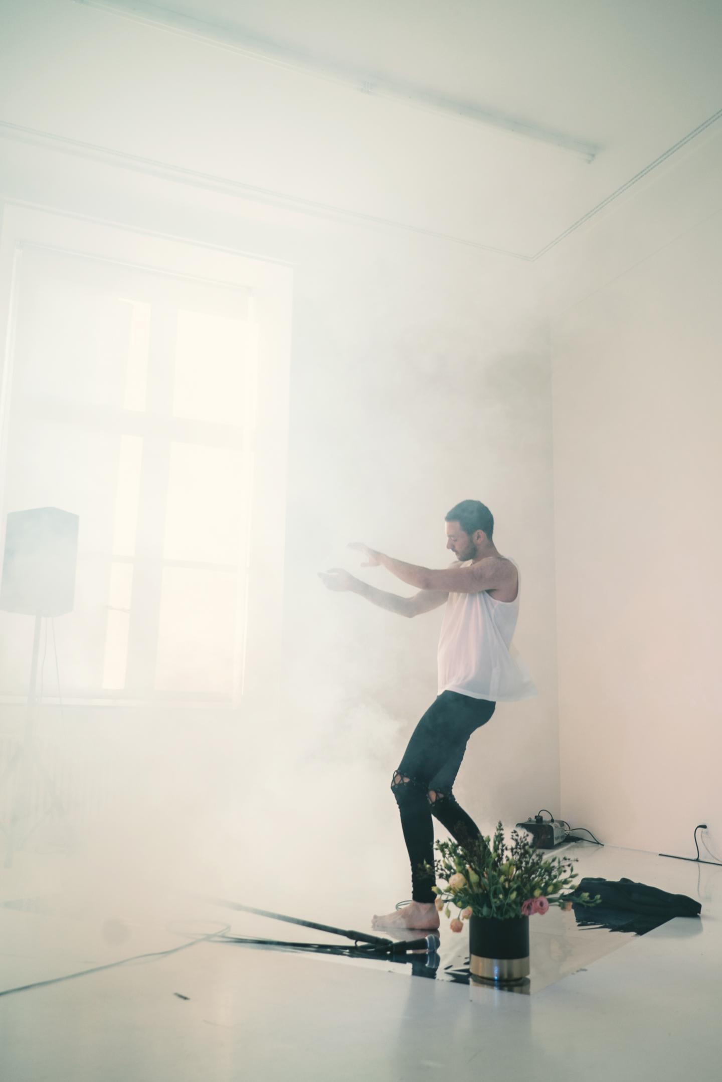 artist dancing in fog