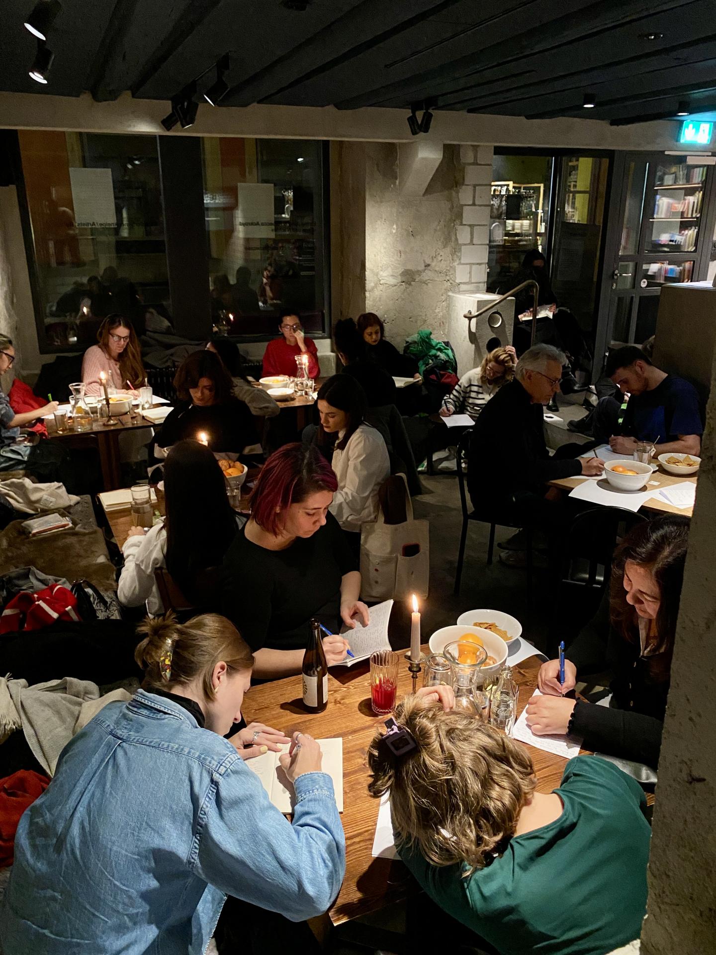 Room filled with people writing 