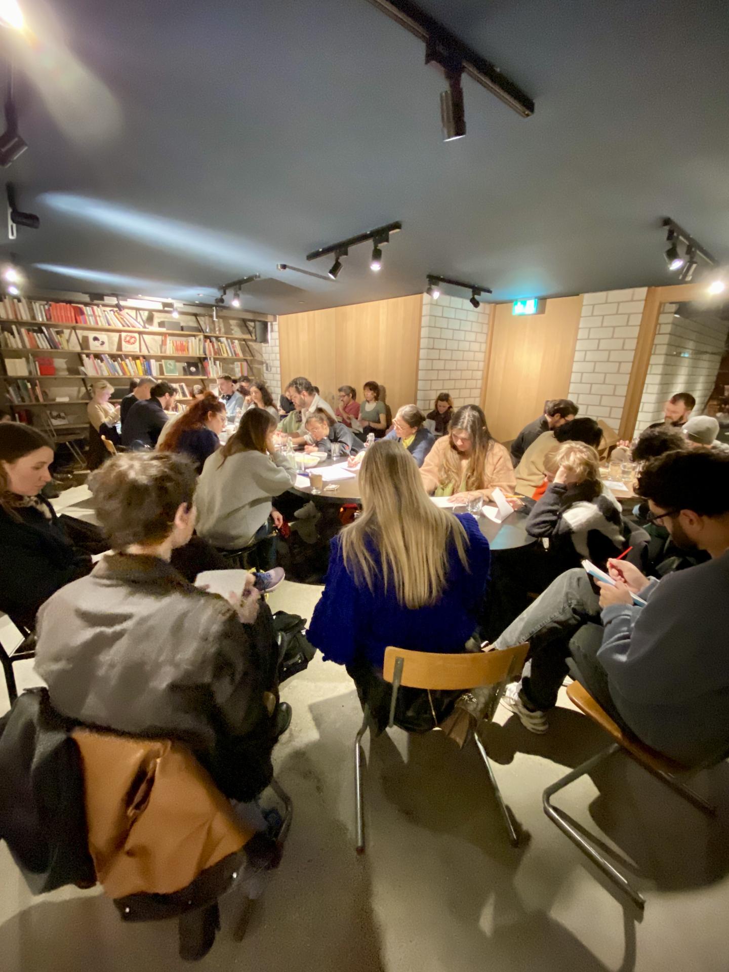 Room filled with people writing 